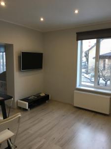 a living room with a flat screen tv on the wall at AV Apartment in Rēzekne