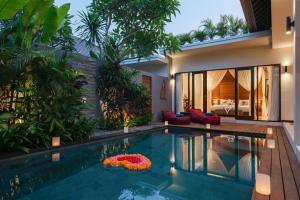 a swimming pool in the backyard of a villa at Villa Sally in Canggu