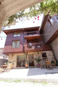 a house with a balcony and a patio at Hotel Albatros Old Town in Sozopol