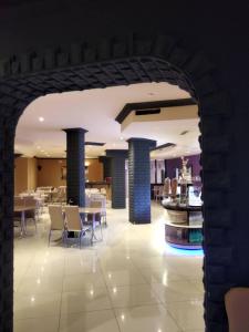 an archway in a restaurant with tables and chairs at M&A Cityhotel Hildesheim in Hildesheim