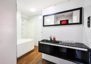a bathroom with a black sink and a tub at Malagueta Beach by Málaga Planners in Málaga +34 photos