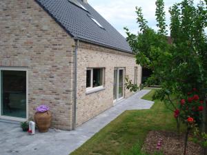 ein Backsteinhaus mit einem Garten und einem Innenhof in der Unterkunft Auro'ra in Zedelgem