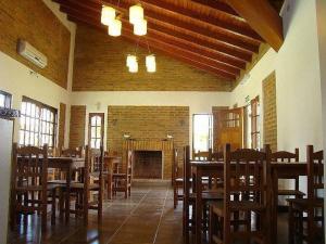 a dining room with wooden tables and chairs at H2O Termal primer y unico hotel Kosher de Argentina in Concordia