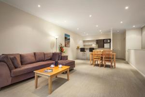 a living room with a couch and a table at Quest Warrnambool in Warrnambool
