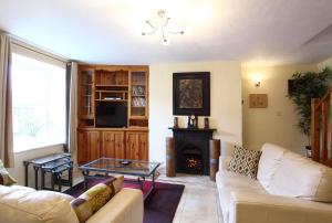 a living room with a couch and a fireplace at Carrig Beag in Kenmare