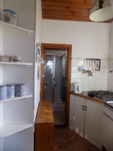 a kitchen with a counter and a door to a bathroom at Casa Mar e Sol. Rinboy , in Ballyhoorisky