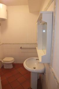 a bathroom with a white toilet and a sink at Le Soleil in Campo nell'Elba +25 photos