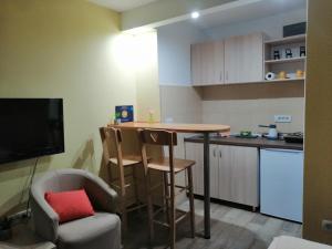 a small kitchen with a table and chairs in a room at Apartment Matovic in Kragujevac