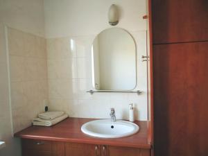 a bathroom with a sink and a mirror at Willa Ewa in Warsaw