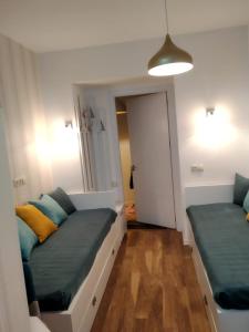 a room with two beds and a hallway with a door at City Center Apartment 2 in Tbilisi City