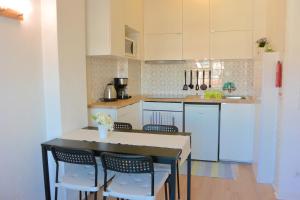 a kitchen with a table and chairs and a counter at Porto Fontainhas, by Flat in Porto in Porto