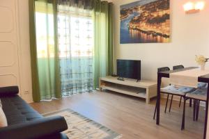 a living room with a tv and a couch and a table at Porto Fontainhas, by Flat in Porto in Porto