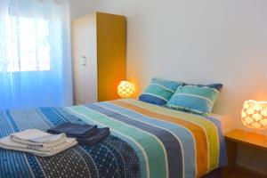 a bedroom with a bed with towels on it at Porto Fontainhas, by Flat in Porto in Porto