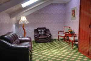 a living room with two leather chairs and a table at City Line Boutique Hotel in Tashkent