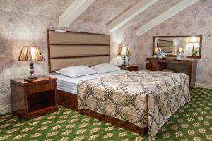 a bedroom with a large bed and a mirror at City Line Boutique Hotel in Tashkent