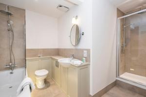 a bathroom with a sink and a toilet and a shower at Heacham Manor Hotel in Hunstanton