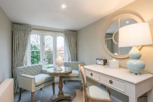 a living room with a desk and a chair at Heacham Manor Hotel in Hunstanton