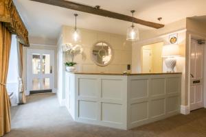 a kitchen with a white counter and a mirror at Heacham Manor Hotel in Hunstanton