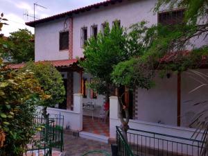 a white house with a fence in front of it at Ancient Olympia Luxury Pool Villa Palace 4Bedroom in Olympia