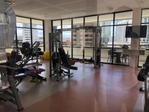 a gym with treadmills and exercise equipment in a building at Studio particular em Hotel in Salvador