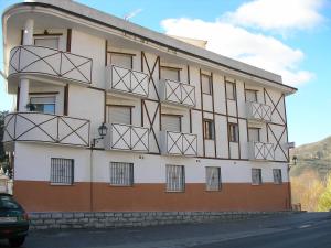 a building with metal balconies on the side of it at Apartamentos Duquesa Sierra Nevada in Pinos Genil