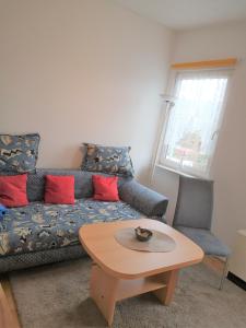 a living room with a couch and a table at Stadtwohnung in Usedom Town