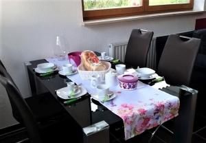 a table with a table cloth with a basket on it at Ferienwohnung-4you in Sigmarszell