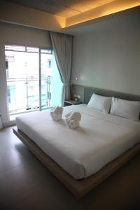 Postel nebo postele na pokoji v ubytování Sunshine Hotel & Residences