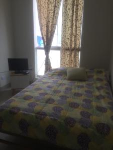 sypialnia z łóżkiem i oknem z zasłonami w obiekcie Departamentos Playa San Bartolo w mieście San Bartolo
