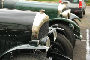 a row of green cars parked in a parking lot at Annandale Arms Hotel in Moffat