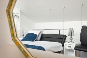 a bed in a room with a mirror at Maison piscine centre ville La Tranche-sur-Mer in La Tranche-sur-Mer +12 photos