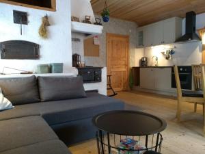 a living room with a couch and a table and a kitchen at Kramer Stugan in Vikarbyn