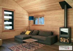 a living room with a couch and a tv at Chalet "La Promesse" in Bagnes