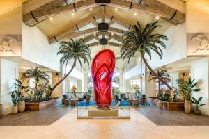 a large red surfboard in a lobby with palm trees at Margaritaville Resort Orlando in Orlando