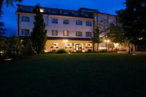 a large building with a lawn in front of it at Albergo La Primula in Potenza