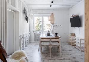 a kitchen with a table and a dog laying on the floor at Local 21A in Zakopane