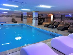 a pool in a hotel with chairs around it at Alrazi Hotel in Istanbul