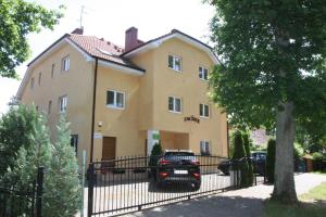 a house with a car parked in front of it at Zacisze Konopnickiej in Pobierowo