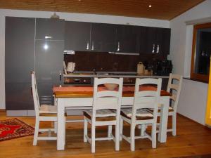 a kitchen with a table and chairs and a refrigerator at Haus Weichart in Sulzburg