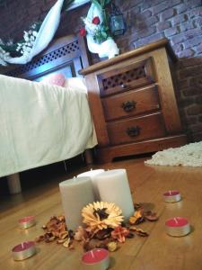 Sopuerta的住宿－Lezamakoetxe，一间房间,地板上放着两根蜡烛和鲜花