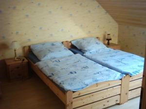 a bedroom with a bed with a rock wall at Zur alten Schmiede in Oederquart