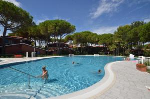 a woman is in a swimming pool at Villaggio Euro Residence Club in Bibione