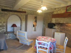 uma cozinha com mesa e cadeiras num quarto em Le clos de la perdrix em Bellenot-sous-Pouilly