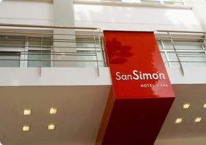 a building with a red sign on the side of it at San Simon Hotel Pereira By Soratama in Pereira