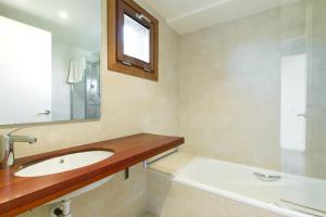 a bathroom with a sink and a mirror at Masia el Prat in El Pont de Vilumara