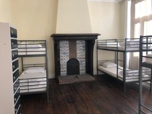 a room with a fireplace and a room with bunk beds at Boomerang Antwerp in Antwerp