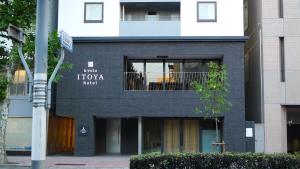 a black building with a sign that reads tkooked at Kyoto Itoya Hotel in Kyoto