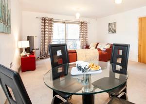 a living room with a glass table and chairs at 16 John Walker House in York