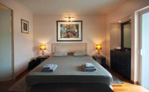 A bed or beds in a room at Athens Lycabettus Hill Penthouse, Private Roof Garden & Pool