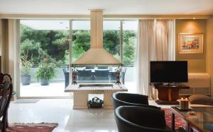 A television and/or entertainment centre at Athens Lycabettus Hill Penthouse, Private Roof Garden & Pool